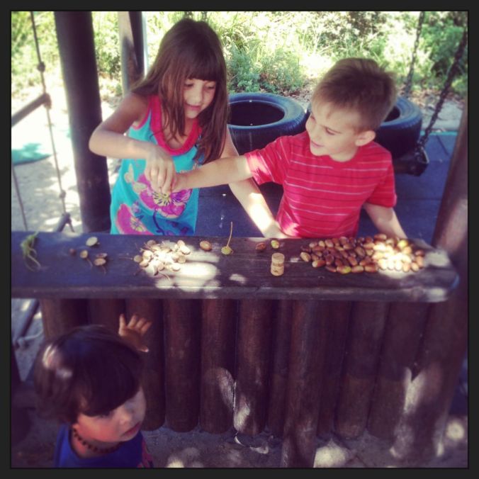 Playing "shop-shop" (like true mini Greeks) with acorns and little playground friends...